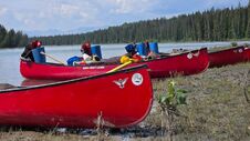 Canoes with the Rockies behind